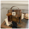 Detail of British style plaid backpack with plush bear charm and vintage texture - Khaki (With Charm)