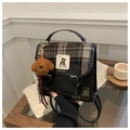 Detail of plaid fabric backpack with leather trim and a cute dog plush keychain - Black (With Charm)