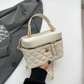 Quilted off-white crossbody bag with golden chain and camellia buckle in a minimalist setting - White