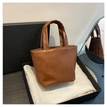 Brown soft leather mini tote with pleated texture displayed in a premium black gift box - Brown