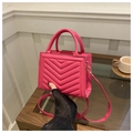 Detail of rose pink quilted crossbody bag with gold hardware and elegant V-stitch pattern - Rose Pink
