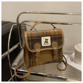 Detail of vintage plaid woolen crossbody bag featuring bear label and leather buckle straps - Khaki