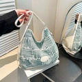Green and white geometric knit bucket bag with white leather straps and oval patch - Green