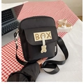 Detail of black canvas shoulder bag with BOX patch and yellow bear charm ornament - With Bear Pendant Style (BX Black) / Black