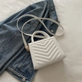 White quilted crossbody bag with V-shaped stitching and gold-tone hardware details - White