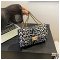 Detail of leopard print bag featuring gold metal buckle and elegant chain strap style - Black
