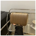 Detail of champagne gold velvet crossbody bag featuring vertical quilted pleats and chain - Khaki