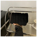 Detailed view of black velvet quilted crossbody bag with gold chain and metal edge trim - Black