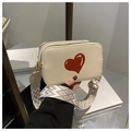 Detail of beige crossbody bag featuring a large red heart and woven geometric strap - Off White