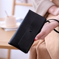 Elegant black faux leather long wallet with snap closure and matching wrist strap - Black