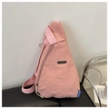 Detail view of pink nylon chest bag with JING PIN metal plate and blue fashion tag - Pink