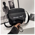 Black nylon crossbody bag featuring cute sausage dog print and a pink bear charm - Black