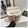 White canvas crossbody bag featuring a cute sausage dog cartoon and matching charm - White