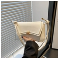 Detailed view of white leather bag with a gold rectangular buckle and knotted rope handle - White