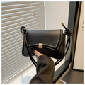 Detail of matte black leather handbag with a gold square buckle and knotted strap - Black