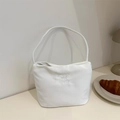 Borsa a tracolla bianca minimalista con ricamo elegante in un ambiente lifestyle chic - Bianco
