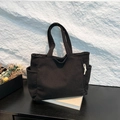 Classic black corduroy tote bag featuring side pockets and double top handles for daily use - Black