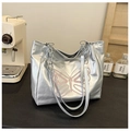 Detail of silver leather tote bag featuring purple butterfly embroidery and chain straps - Silver