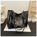 Detail of black tote bag with pink butterfly embroidery and metal chain strap - Black