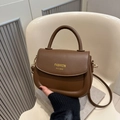 Compact brown leather saddle bag with gold FASHION lettering and crossbody strap - Brown