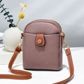 Detail of lychee textured crossbody phone bag with dual gold zippers and brown strap - Purple