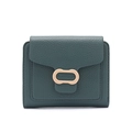 Detailed macro view of dark green litchi texture leather and gold metal ring buckle - Green