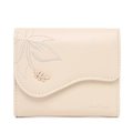 Detail view of cream trifold wallet with floral embroidery and gold leaf metal buckle - Beige Apricot