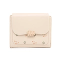 Close-up of floral print pattern and metal flower clasp on beige short wallet for women - Apricot