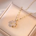 Macro shot of a four-leaf clover necklace with pink zircons and gold chain in a jewelry box - Gold Clover - Pink Purple Zirconia (4)