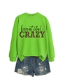 Flat lay of neon green sweatshirt with 'beautiful CRAZY' print and denim shorts - Fluorescent Green (Black Graphic)