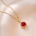 Macro shot of gold necklace featuring round red gemstone pendant with micro-pave crystals - Gold/Red Zirconia