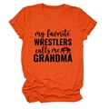 Gros plan sur un T-shirt en coton orange avec silhouette de lutteur et texte noir - S / Orange