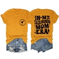 Flat lay of ginger crew neck t-shirt with Taekwondo Mom Era print and denim shorts - S / Mustard Yellow (Black Font)