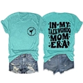 Flat lay view of mint green taekwondo t-shirt showing front logo and back typography - Deep Water Blue (Black Font)