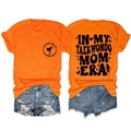 Orange In My Taekwondo Mom Era T-shirt paired with denim shorts, front and back view - Orange (Black Font)