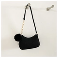 Detail of black crescent shoulder bag featuring V-shaped quilting and gold chain accent - Black