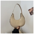 Close-up of cream half-moon underarm bag showing smooth matte leather and silver hardware - Khaki