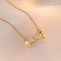 Elegant gold infinity necklace with pavé cubic zirconia on champagne silk background - Infinity Necklace (X0689--1) / Gold