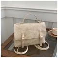 Detail of beige vintage faux leather backpack with embossed logo and metal buckles - Khaki
