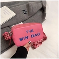 Detail of pink faux leather mini bag with lychee texture and blue letter print - Rose Red