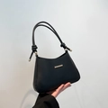 Minimalist black matte leather underarm bag featuring a knotted handle and golden hardware - Black