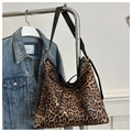 Detail view of leopard print tote bag with bow drawstring and black shoulder straps - Brown
