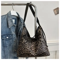 Detail view of leopard print tote bag with black bow tie hanging on a metal hanger - Black