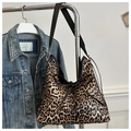 Detail of leopard print hobo bag with black leather strap and bow tied on front - Khaki