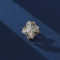 Elegant gold flower brooch with four crystal petals on a textured dark blue background - Rotating Four-Leaf Flower Style (XX0141)