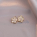 Elegant gold-tone flower stud earrings with shimmering clear cubic zirconia petals - White Earrings (E0285)
