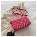 Detail of bright pink square handbag featuring a 3D V-shaped geometric texture and top handle - Rose Pink