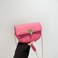 Pink semi-circle crossbody bag with gold studs and textured lychee leather finish - Pink