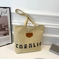 Borsa tote in tela beige minimalista con testo artistico nero e logo in pelle - Giallo