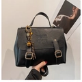 Retro black leather tote bag with gold hardware and COIN logo, hand-held view - With Charm / Black